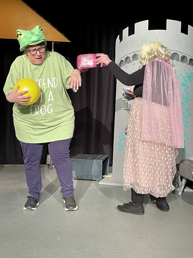 Sally, playing the frog, talking to Jackie, the Princess.